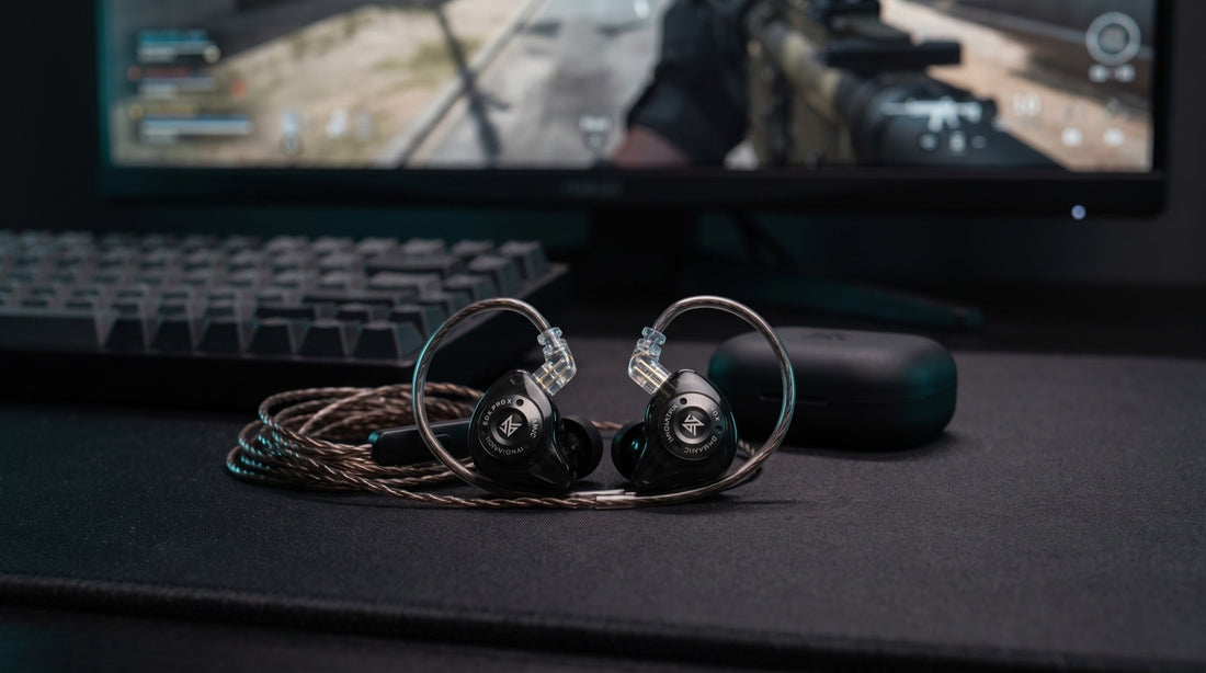 Gaming IEMs on a desk with mechanical keyboard and ultrawide monitor